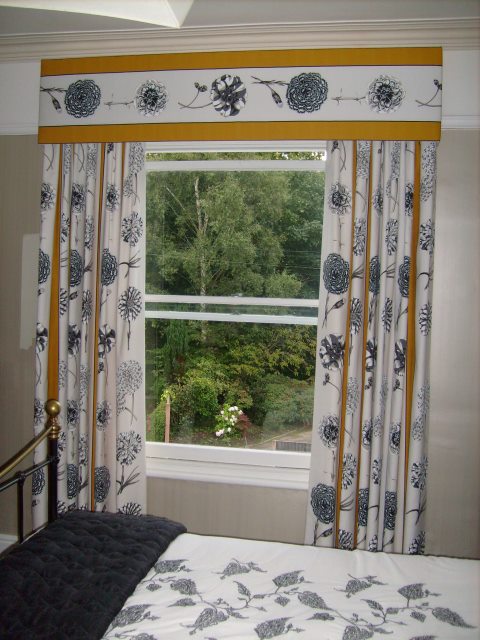 Bedroom curtain pelmet with the fabric running across. So allowing the full benefit of the fabric design. The matching curtains have the design running down the curtains.