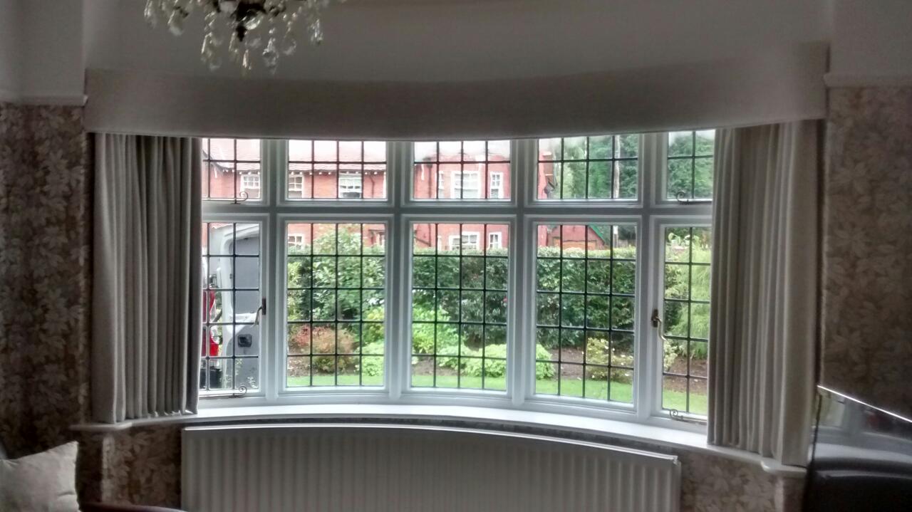 Curved bay window pelmet with simple lines for an understated look.